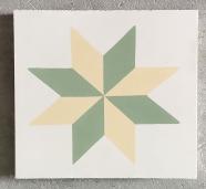 Mosáico hidráulico con forma de estrella geométrica en verde y amarillo